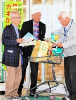 来店者にチラシを渡して注意を呼びかける大久保理事長（左）
