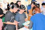 謎解きに挑戦しようと、受付で台紙を受け取る参加者ら＝２日、北栄町由良宿の青山剛昌ふるさと館