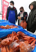 生のベニズワイガニを購入する買い物客