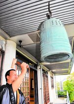 平和の鐘を打ち鳴らす妙要寺の鶴巻順教住職＝１５日正午、鳥取市寺町