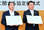 水害時における損害調査結果の提供・利用に関する協定書に署名した坪井山陰支店長（右）と平井知事＝９日、鳥取県庁