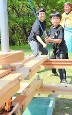 ロープを引っ張って火をおこす親子＝４月２９日、大山町妻木