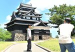 松江城での撮影に臨む溝端さん（左）＝１８日、松江市殿町