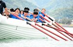 声をかけ合い懸命にオールをこぐ生徒たち＝５月３０日、香美町香住区下浜の香住湾