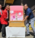 伯桜鵬関倉吉後援会長の広田市長から化粧まわしを受け取る伯桜鵬関の父・落合勝也さん（右）＝７日、鳥取県倉吉市明治町の打吹回廊