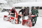 除雪機で雪をかく隊員ら＝２３日、日野町上菅