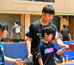木造選手からサーブの打ち方などを教わる参加者＝１２日、鳥取市天神町の鳥取産業体育館