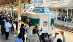 ＪＲ米子駅を出発する緑色の「やくも」に手を振る鉄道ファンら＝５日、鳥取県米子市のＪＲ米子駅