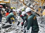 　２８日、地震による建物の倒壊現場で作業する人ら＝タイ・バンコク（タイ軍提供・共同）