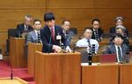 　愛知県豊橋市の新アリーナ整備を巡り、事業継続の賛否を問う住民投票条例案の審議で答弁する長坂尚登市長（手前）＝１５日午後、豊橋市議会