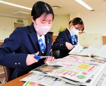 新聞を読み、気になった記事をスクラップする新入職員＝２日、倉吉市昭和町１丁目の倉吉信用金庫