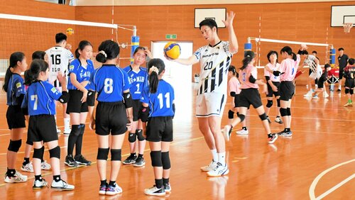 選手からスパイクのこつを教わる小学生ら