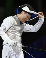 　男子フルーレ個人３位決定戦で敗れ、マスクを外す飯村一輝＝パリ（共同）
