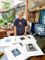植田が集めたオブジェなどが並ぶダイニングルームで「生家は写真仲間でにぎやかだった」と語る植田亨さん＝境港市末広町の生家