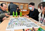 さいころを投げてすごろくを楽しむ参加者＝２４日、鳥取市青葉町３丁目の城北地区公民館
