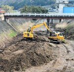 千代川と大井手川をつなぐ放水路内の堆積土砂を掘削する重機＝４月１１日、鳥取市河原町河原（国土交通省鳥取河川国道事務所提供）
