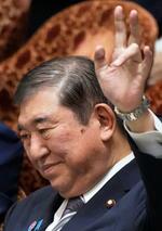 　衆院予算委の集中審議で答弁のため手を挙げる石破首相＝１２日午前