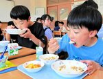 台湾の郷土料理などを口いっぱいにほおばる児童ら