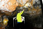 溶岩トンネル「竜渓洞」の内部を案内する野津さん