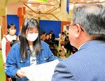 広田市長（手前）から賞状を手渡される岩本さん＝２１日、倉吉市山根のパープルタウン