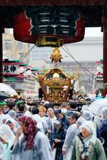　浅草神社の三社祭で雷門をくぐるみこし。中日の「連合渡御」が行われ、雨の中集まった大勢の見物客を魅了した＝１７日午後、東京都台東区