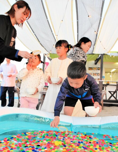 スーパーボールすくいを楽しむ子どもたち＝２６日、米子市の皆生温泉海遊ビーチ