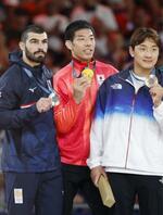　男子８１キロ級で五輪２連覇を果たし、表彰式で金メダルを手にする永瀬貴規（中央）＝パリ（共同）