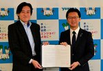 協定書を交わす湯村専務（左）と伊木市長＝２２日、米子市役所