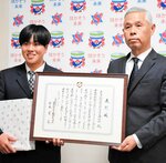 田辺副会長（右）から表彰状と記念品を受け取り笑顔を見せる河本さん