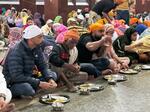 　大部屋で食事をする来訪者ら＝２０２５年３月、インド・アムリツァル（共同）