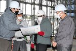 鳥取県立美術館の設計担当者らに建設現場を案内されるジャクソンさん（右から２人目）＝２７日、倉吉市駄経寺町２丁目