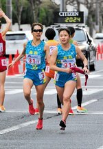１区堀尾（左）が区間２６位と粘って２区河本につなげる＝第１中継所