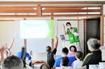 講話会で大田さん（写真奥）の解説を聞く参加者ら＝１７日、新温泉町浜坂の「ここすぺーす」