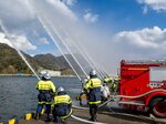 境水道に向け水の弧を描く一斉放水＝７日、境港市大正町