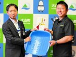 目録と石箕を渡す小林所長（左）