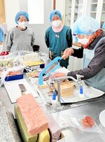 力を入れてかき餅を切断する参加者