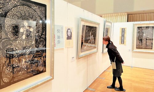 流麗な曲線で描かれた切り絵が並ぶ会場＝２６日、倉吉未来中心