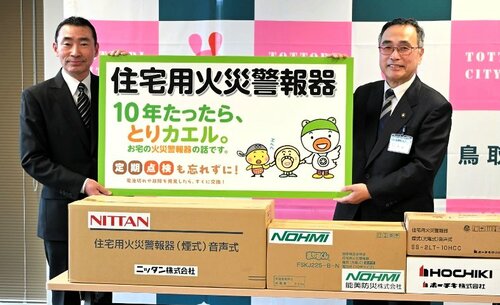 深沢市長（右）に住宅用火災警報器を引き渡す山下会長