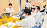 来場者に製品を紹介するメーカー担当者（左）