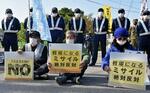 　陸上自衛隊勝連分屯地へ向かう道で抗議する人たち＝１０日午前、沖縄県うるま市