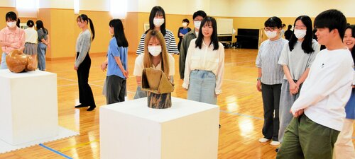 展示された作品をグループで鑑賞する学生たち