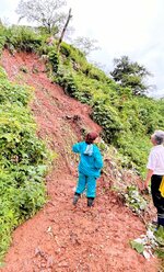 土砂が崩れた現場を確認する米子市職員＝１３日、同市久米町