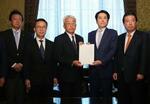 　政治資金規正法改正案を岡田憲治・衆院事務総長（中央）に提出する立憲民主党と国民民主党などの議員ら＝２０日午前、国会
