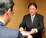 伊木市長（手前）に目録を手渡す坂口社長＝２０日、米子市役所