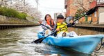 パドルを操りながら加茂川でのカヤック体験を楽しむ親子