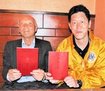 句集「来温の詩１」を手にする石賀さん（左）と佐々木さん