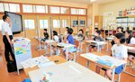 中村記者（左端）から新聞の読み方のこつを教わる児童たち＝１９日、香美町小代区実山の小代小