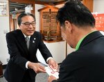 岸田理事長に協賛金を手渡す加藤副市長（左）