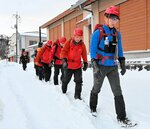 大山寺駐在所を出発する捜索隊員ら＝３日午前７時ごろ、鳥取県大山町大山