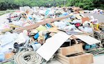矢田川クリーンセンター跡地の仮置き場に山積みされた災害ごみ＝２３日、香美町香住区油良